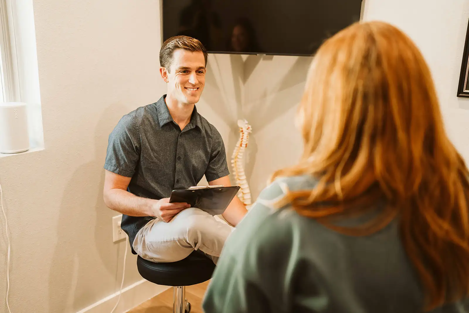 Dr. Spencer Hiebert listening to a patient during a consultation
