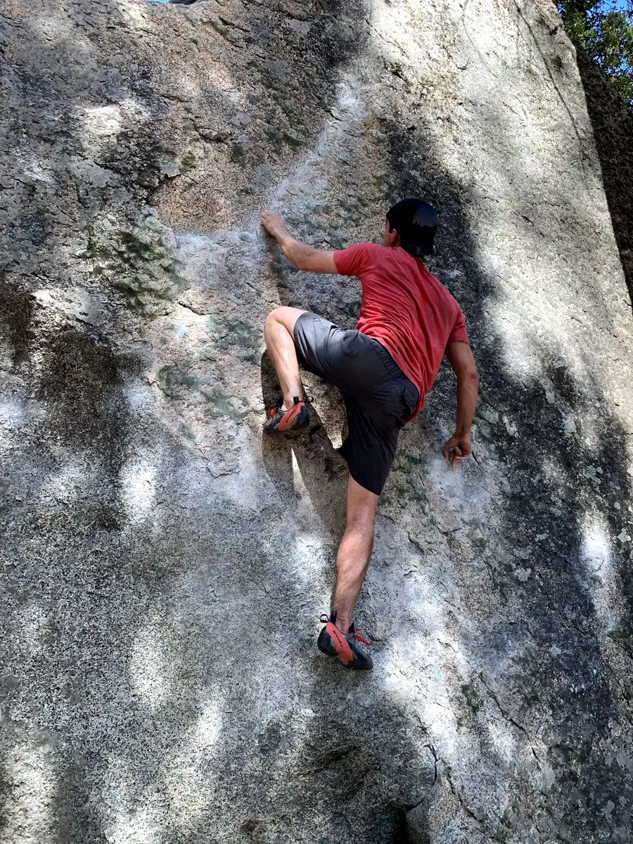 Dr. Spencer Hiebert bouldering on a granite rock face
