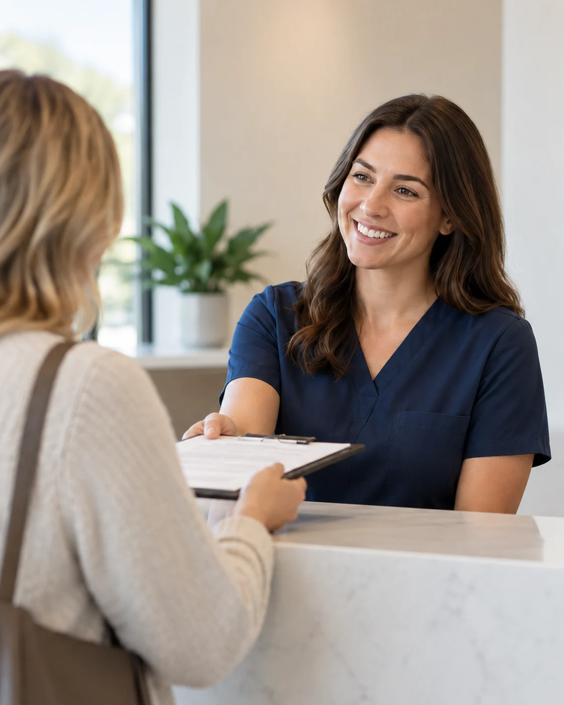 A clinic team member discusses paperwork with a patient