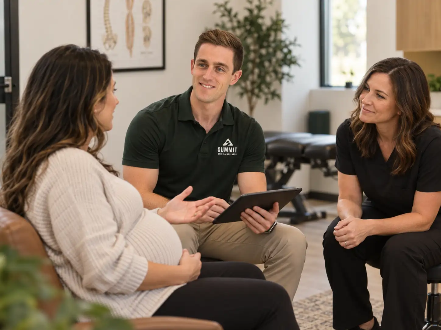 Pregnant patient discussing her care during a wellness consultation