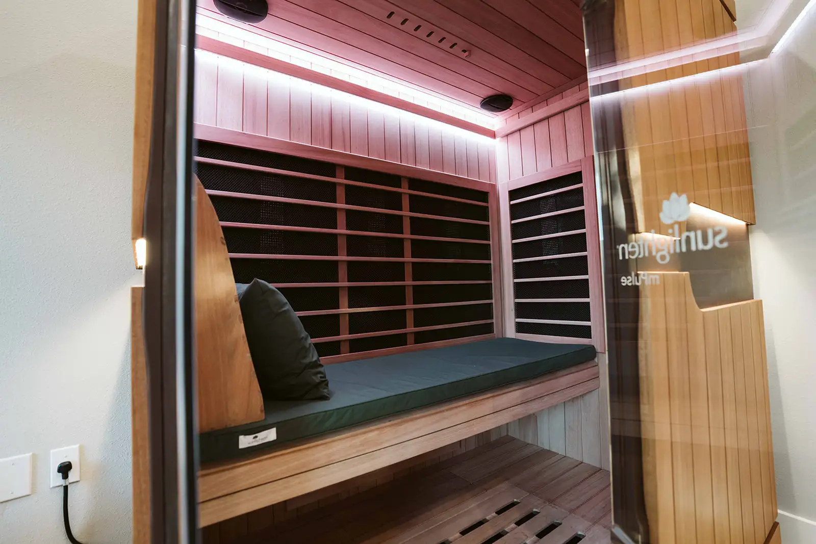 Padded seating inside Summit's wood-lined Sunlighten infrared sauna
