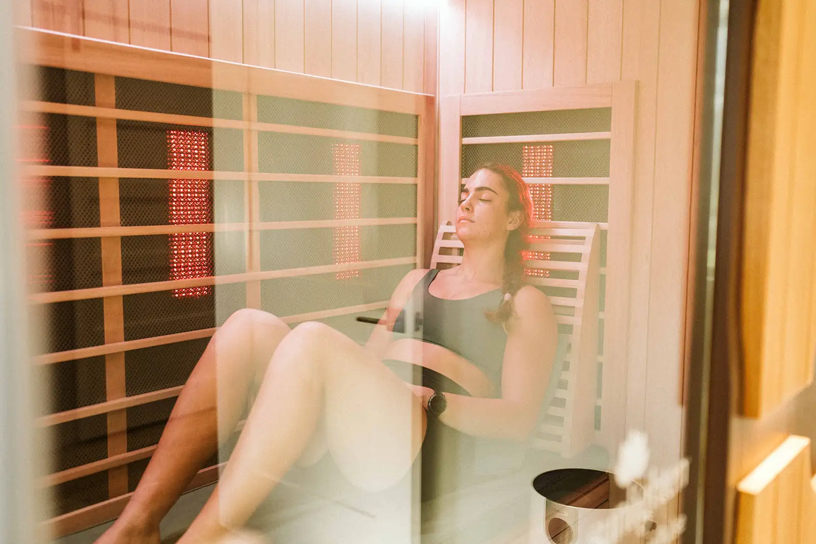 Woman relaxing in a wooden infrared sauna
