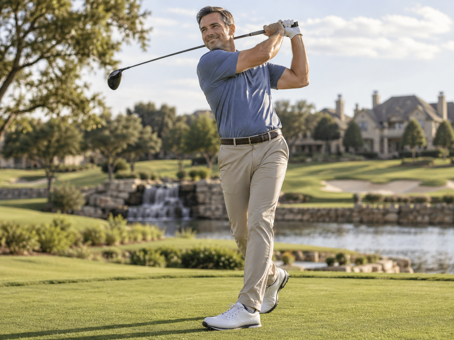 Golfer completing a follow-through on a golf course