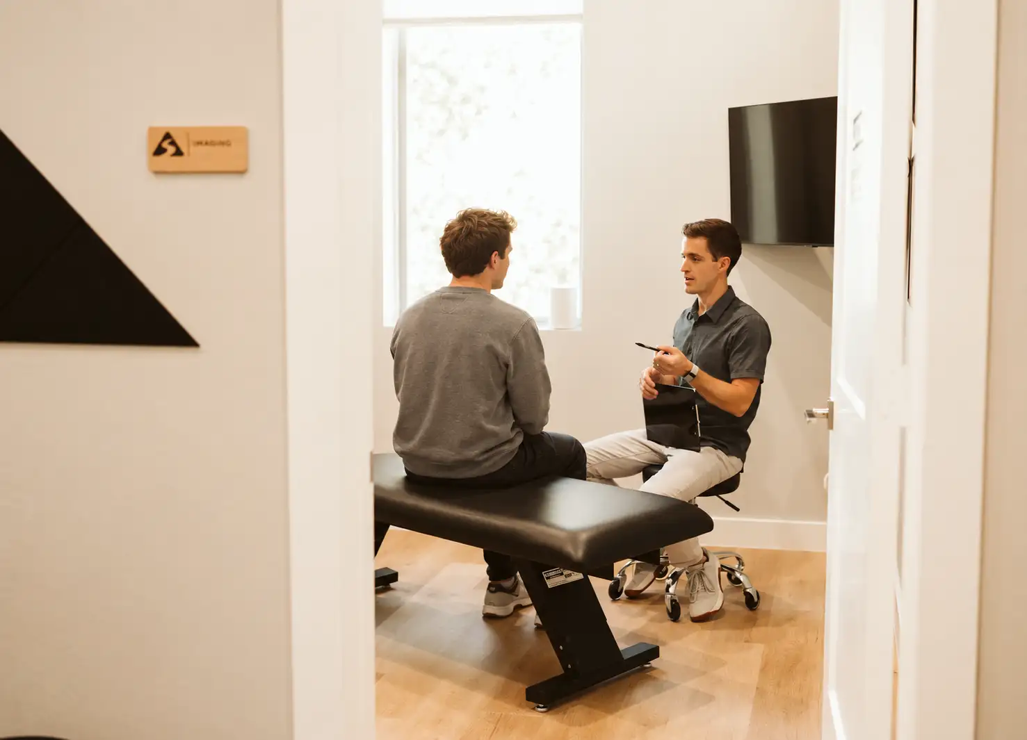 Patient discussing back pain and care goals during a clinic consultation