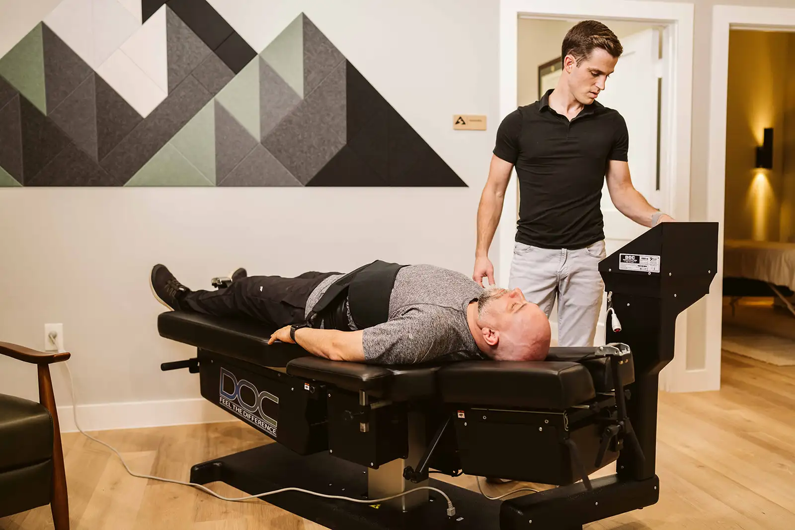 Dr. Hiebert monitoring a patient during a spinal decompression session at Summit Spine & Wellness
